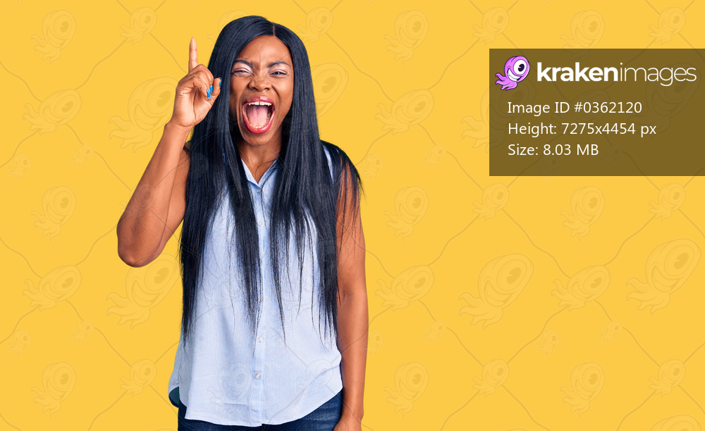 Young african american woman wearing casual clothes pointing finger up with successful idea. exited and happy. number one. 