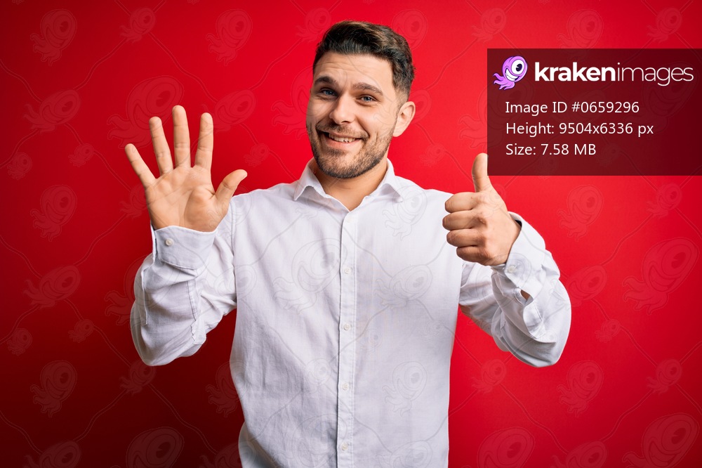 Young business man with blue eyes wearing elegant shirt standing over red isolated background showing and pointing up with fingers number six while smiling confident and happy.