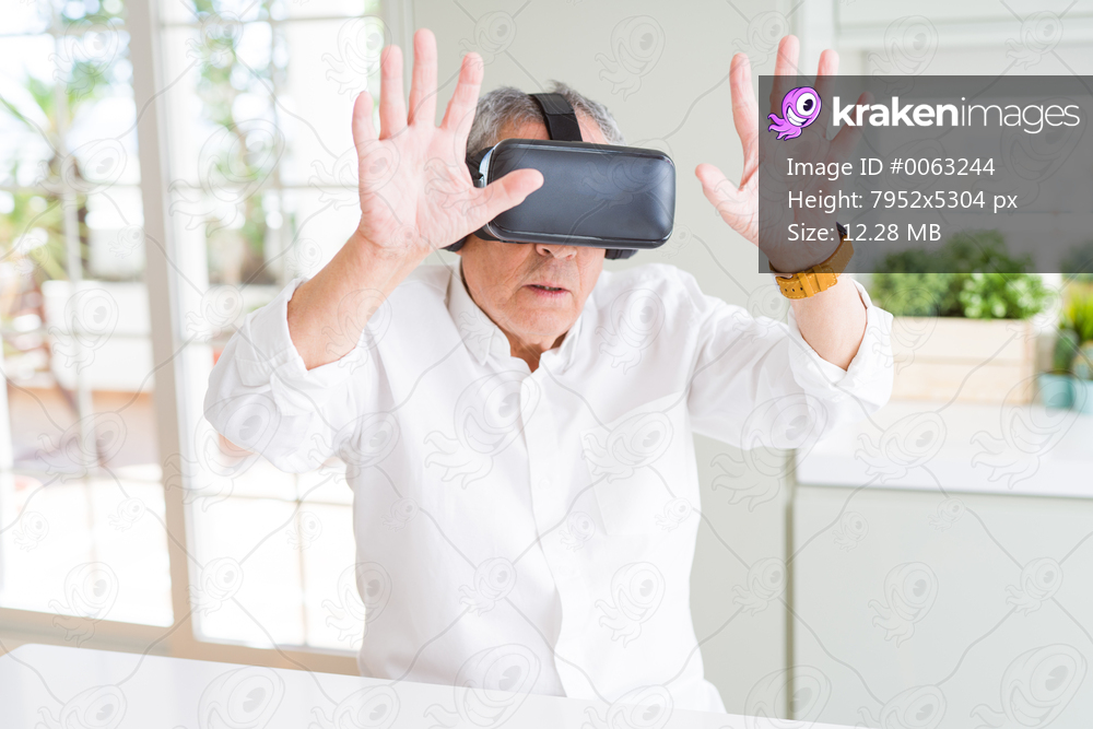 Man wearing virtual reality glasses looking concentrated