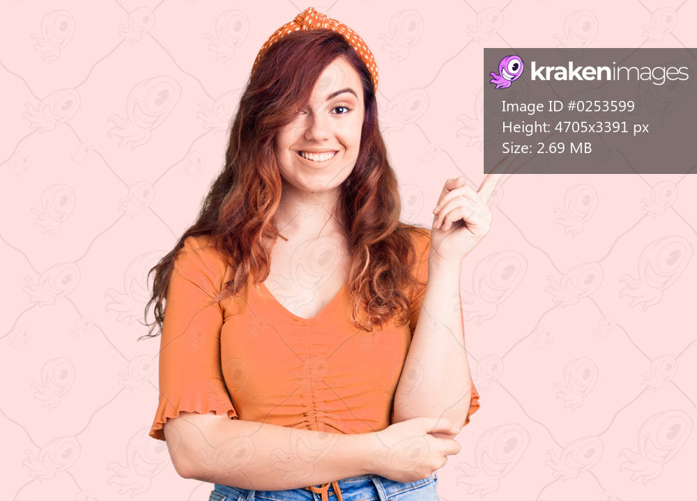 Young beautiful woman wearing casual clothes smiling happy pointing with hand and finger to the side 