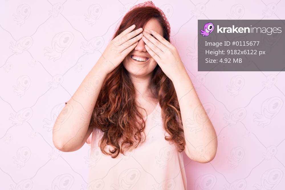 Young beautiful woman wearing casual clothes covering eyes with hands smiling cheerful and funny. blind concept. 