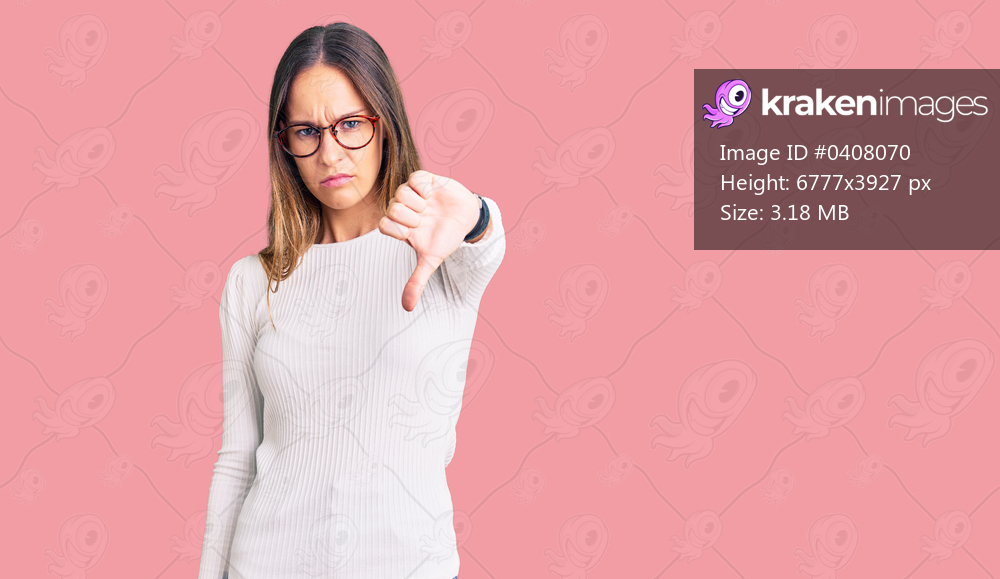 Beautiful brunette young woman wearing casual white sweater and glasses looking unhappy and angry showing rejection and negative with thumbs down gesture. bad expression. 