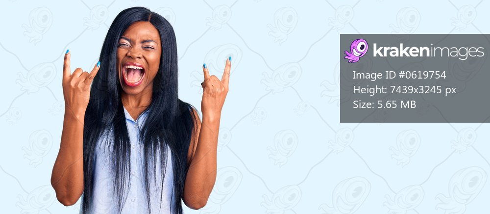 Young african american woman wearing casual clothes shouting with crazy expression doing rock symbol with hands up. music star. heavy concept. 