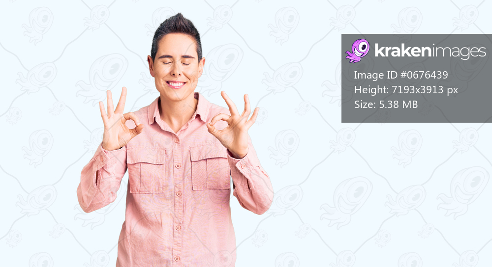 Young woman with short hair wearing casual clothes relaxed and smiling with eyes closed doing meditation gesture with fingers. yoga concept. 