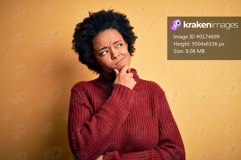 Young beautiful African American afro woman with curly hair wearing casual turtleneck sweater Thinking worried about a question, concerned and nervous with hand on chin