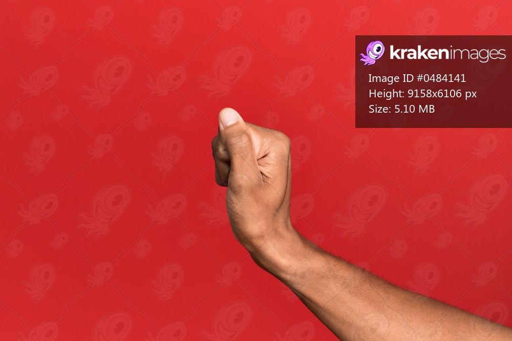 Hand of hispanic man over red isolated background holding blank space with thumb finger, business and advertising 