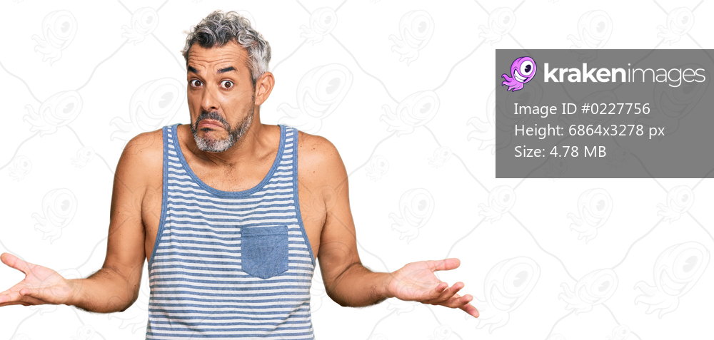 Middle age grey-haired man wearing casual style with sleeveless shirt clueless and confused expression with arms and hands raised. doubt concept. 