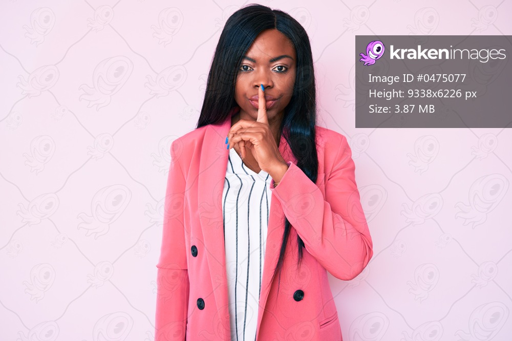 Young african american woman wearing business clothes asking to be quiet with finger on lips. silence and secret concept. 