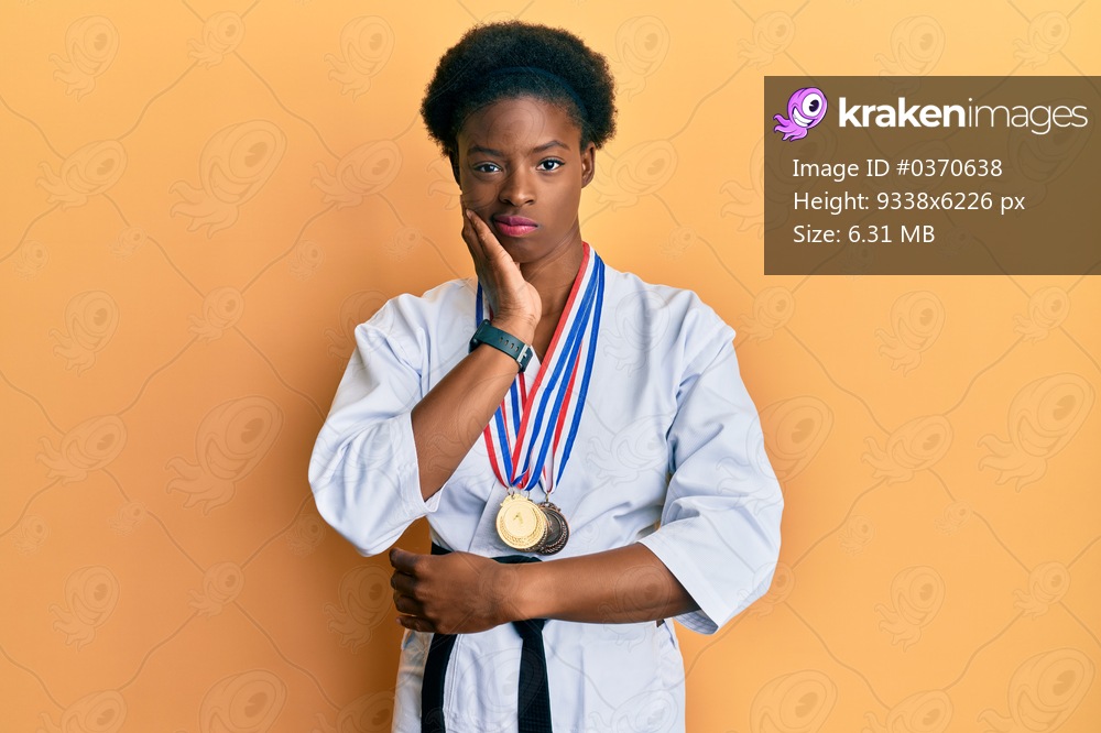 Young african american girl wearing karate kimono and black belt thinking looking tired and bored with depression problems with crossed arms. 