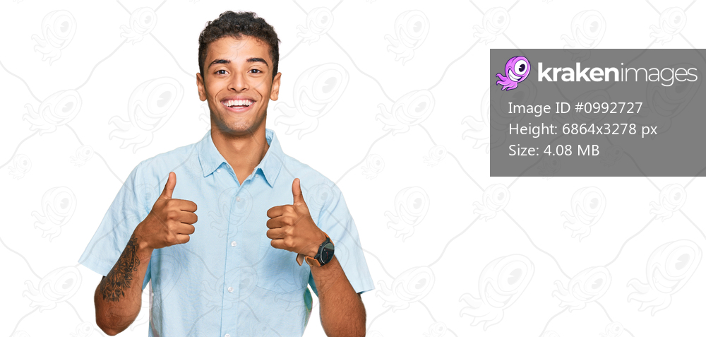 Young handsome african american man wearing casual clothes success sign doing positive gesture with hand, thumbs up smiling and happy. cheerful expression and winner gesture. 