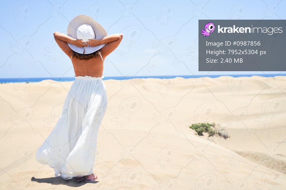 Young beautiful woman smiling happy enjoying summer vacation at maspalomas dunes beach