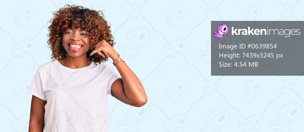 Young african american woman wearing casual white tshirt smiling doing phone gesture with hand and fingers like talking on the telephone. communicating concepts. 