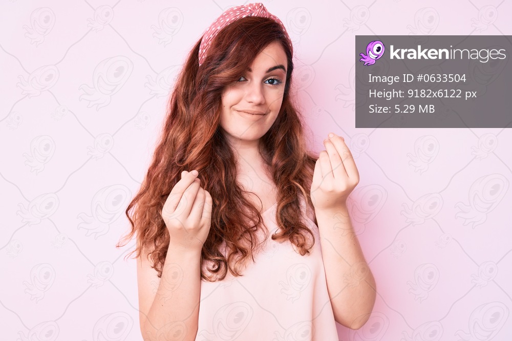 Young beautiful woman wearing casual clothes doing money gesture with hands, asking for salary payment, millionaire business 