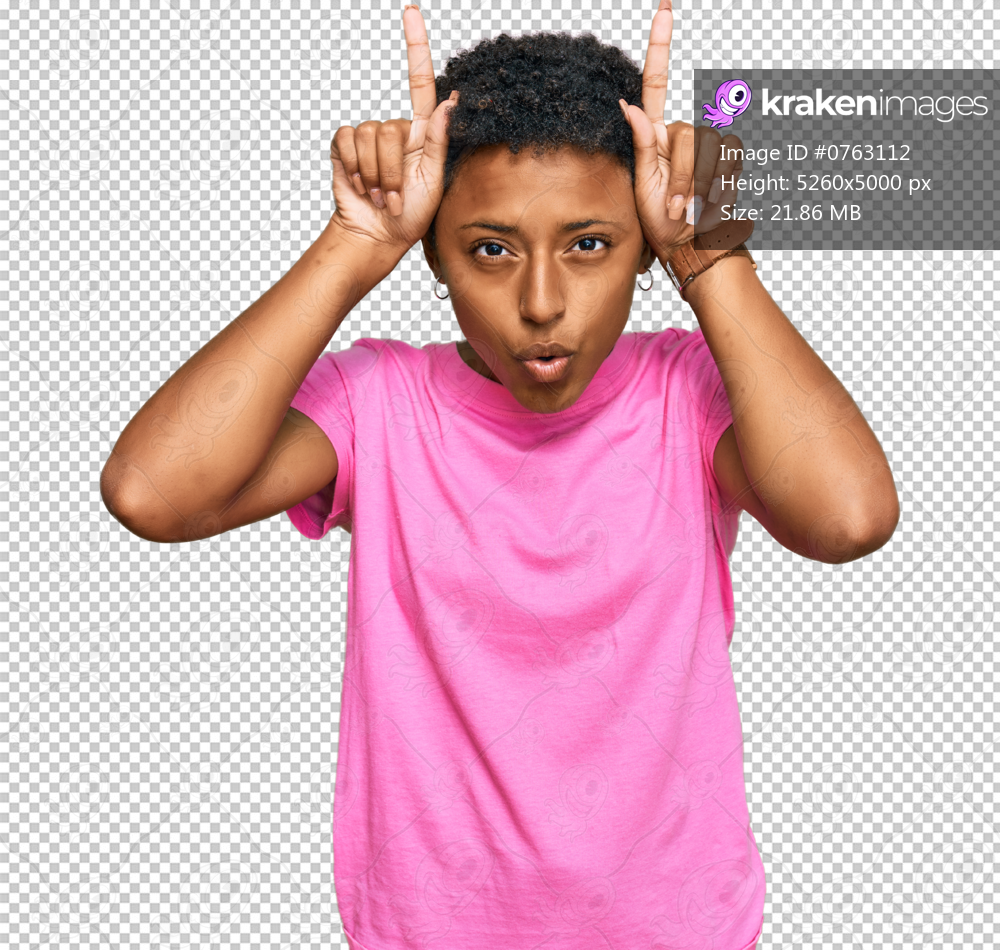 Young african american woman wearing casual clothes doing funny gesture with finger over head as bull horns