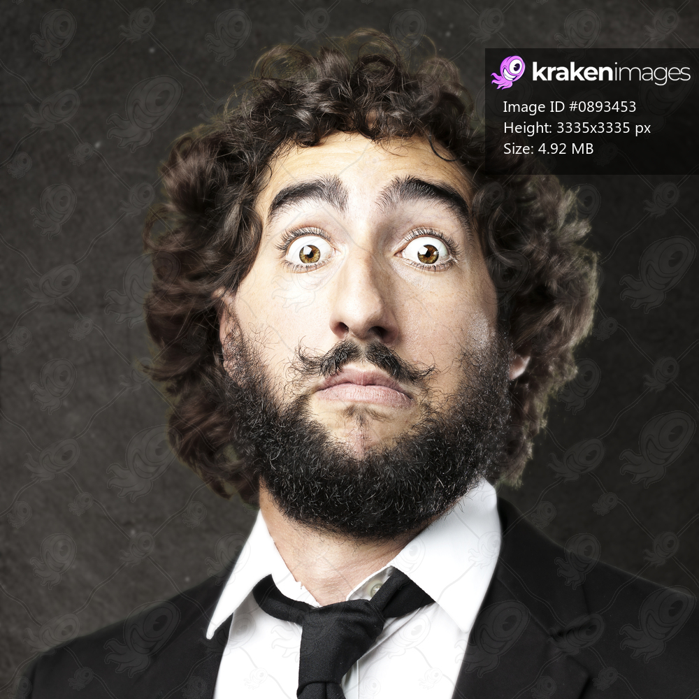 portrait of afraid young man against a grunge wall