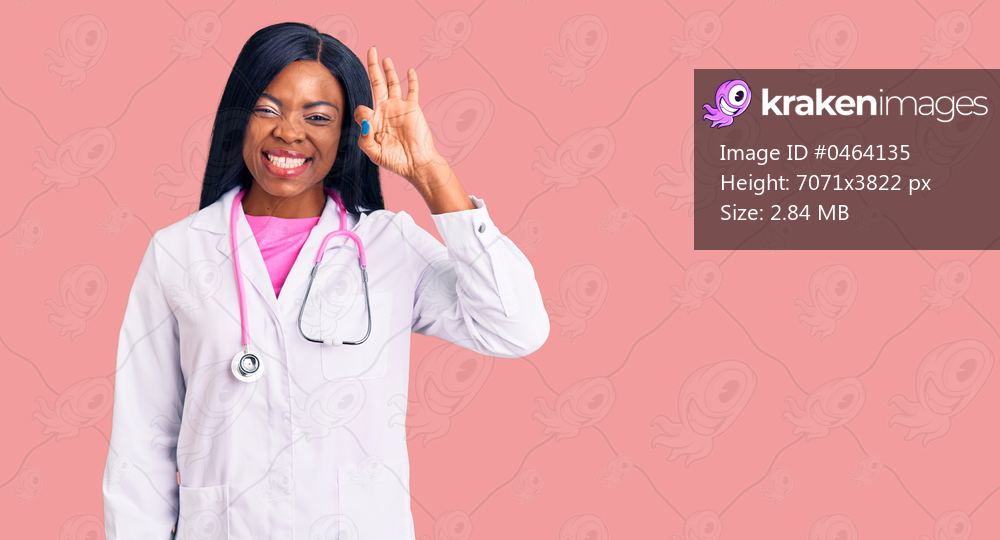 Young african american woman wearing doctor stethoscope smiling positive doing ok sign with hand and fingers. successful expression. 
