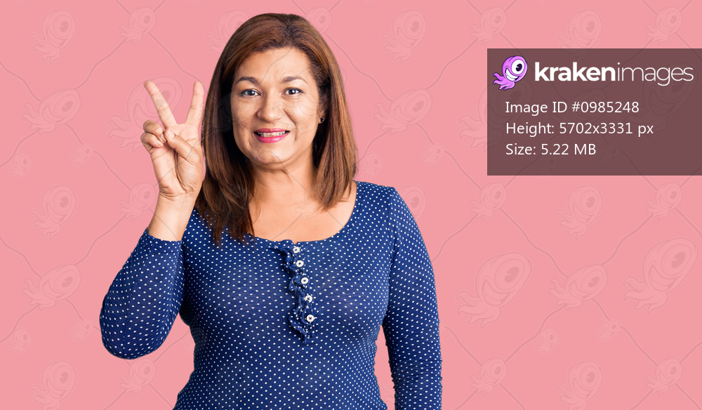 Middle age latin woman wearing casual clothes smiling with happy face winking at the camera doing victory sign. number two. 