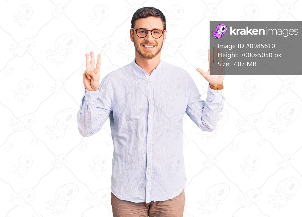 Handsome young man with bear wearing elegant business shirt and glasses showing and pointing up with fingers number eight while smiling confident and happy. 
