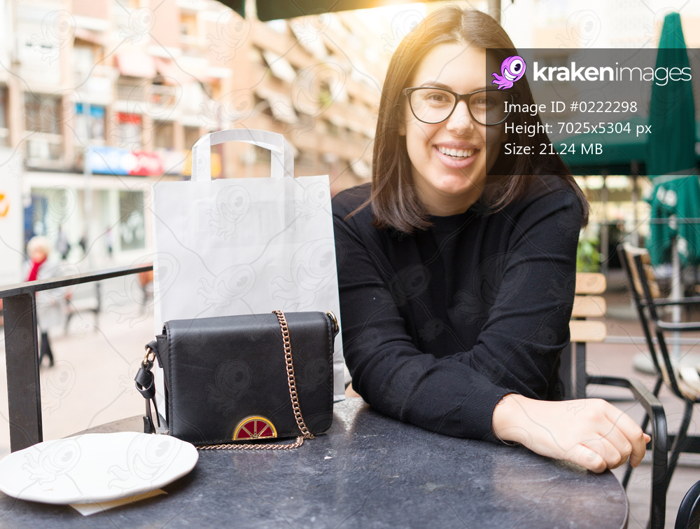 Beautiful young woman smiling happy sitting at the cafeteria of the town