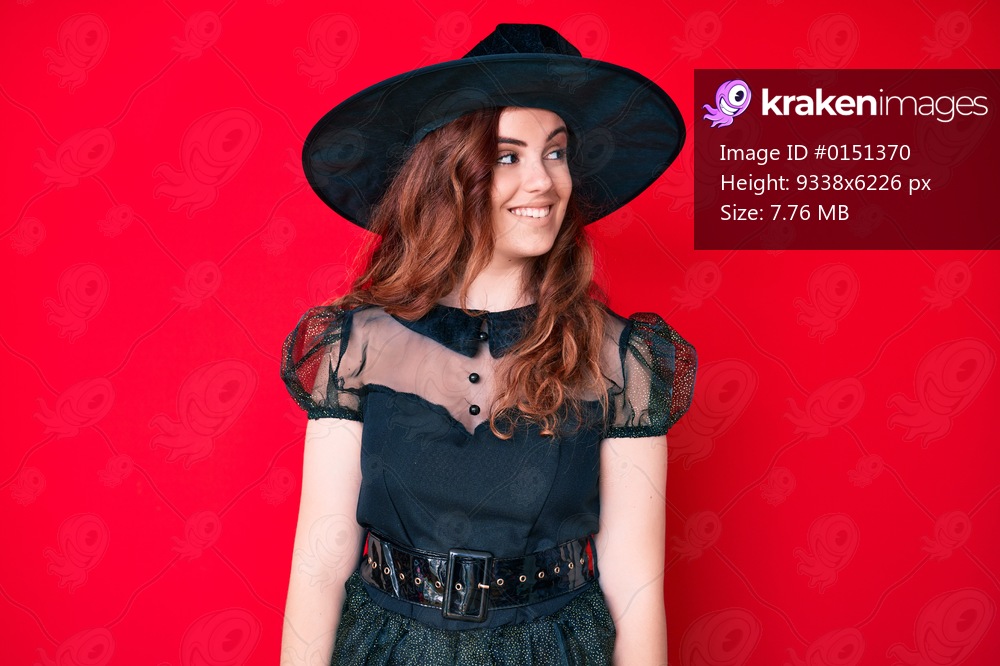Young beautiful woman wearing witch halloween costume looking to side, relax profile pose with natural face and confident smile. 