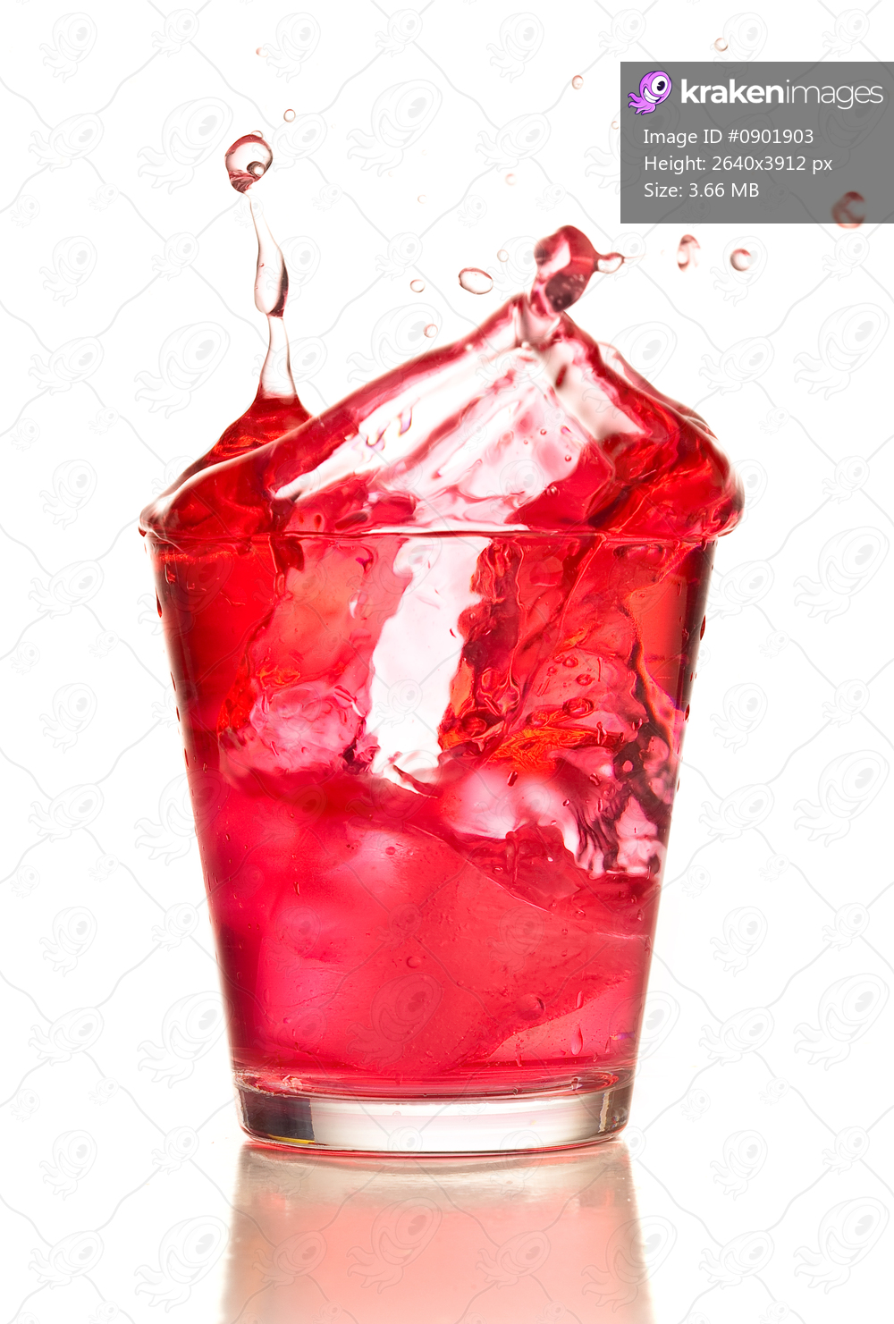cocktail splashing into glass on white background