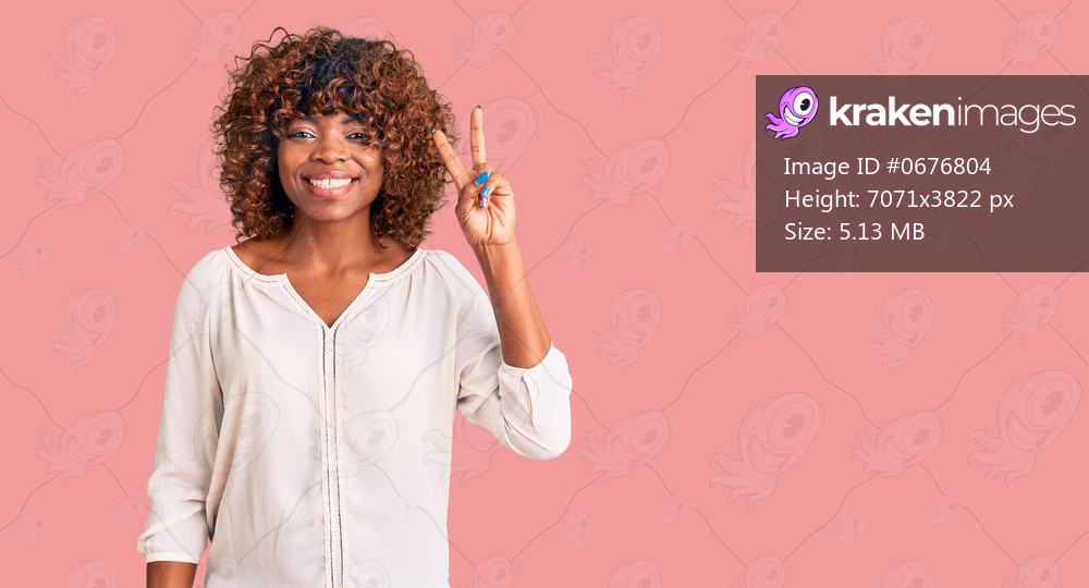 Young african american woman wearing casual clothes smiling with happy face winking at the camera doing victory sign. number two. 
