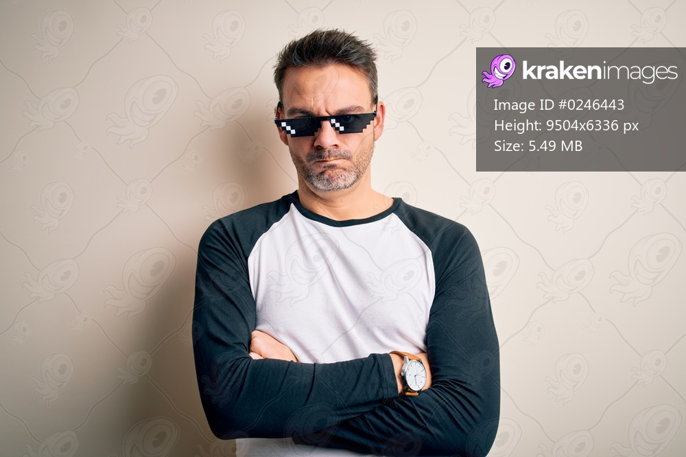 Young handsome man wearing funny thug life sunglasses meme over white background skeptic and nervous, disapproving expression on face with crossed arms. Negative person.