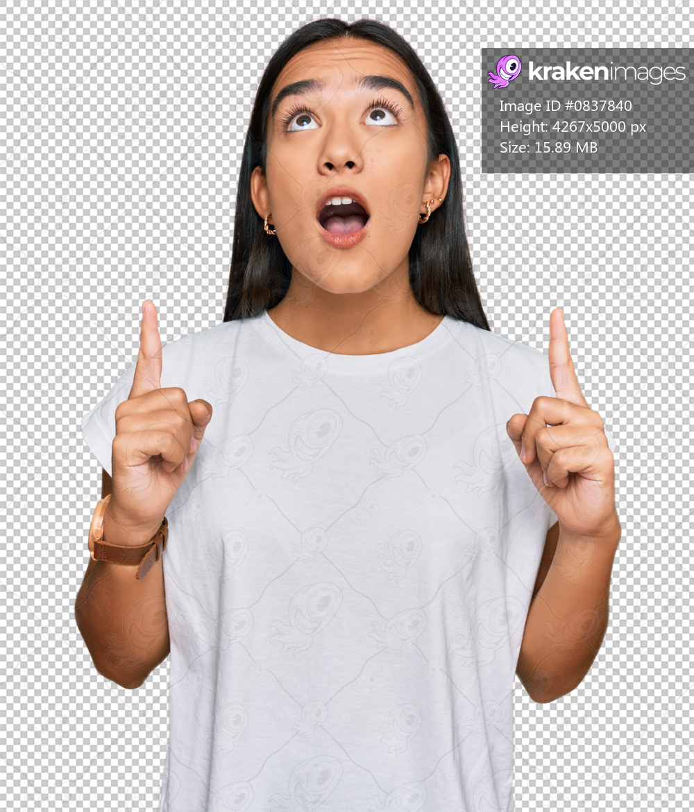Young asian woman wearing casual white t shirt amazed and surprised looking up and pointing with fingers and raised arms.