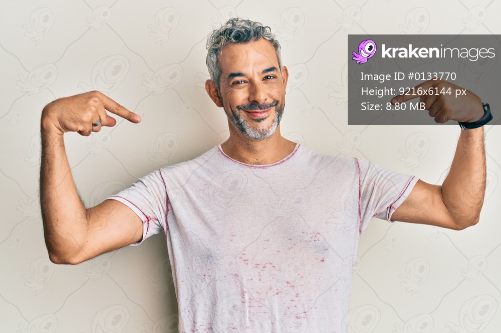 Middle age grey-haired man wearing casual clothes looking confident with smile on face, pointing oneself with fingers proud and happy. 