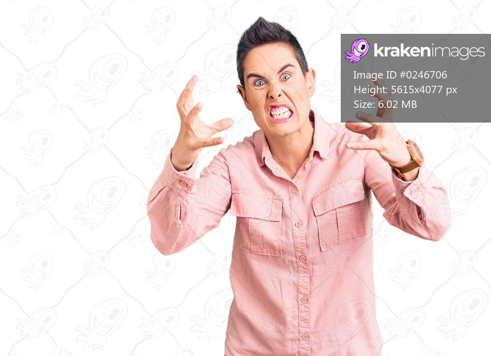 Young woman with short hair wearing casual clothes shouting frustrated with rage, hands trying to strangle, yelling mad 
