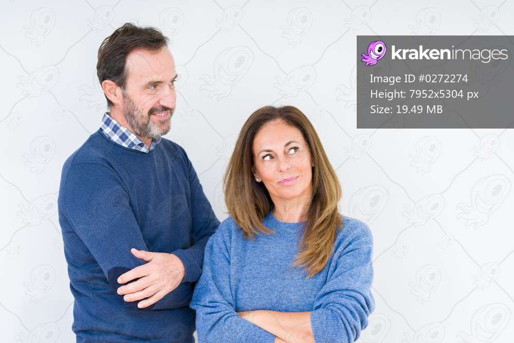 Beautiful middle age couple in love over isolated background smiling looking side and staring away thinking.