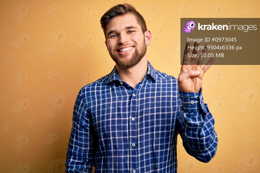 Young blond businessman with beard and blue eyes wearing shirt over yellow background showing and pointing up with fingers number four while smiling confident and happy.