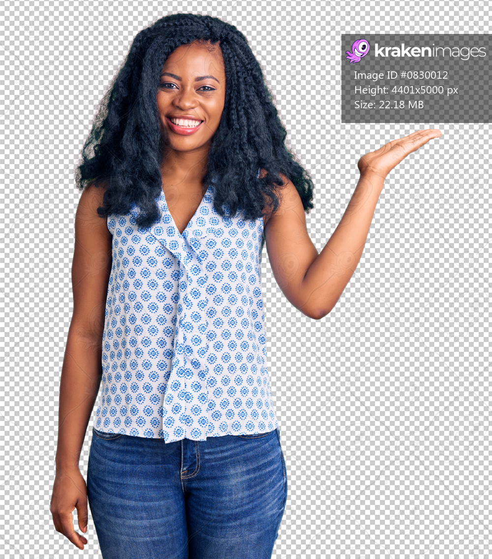 Beautiful african american woman wearing casual summer shirt smiling cheerful presenting and pointing with palm of hand looking at the camera.