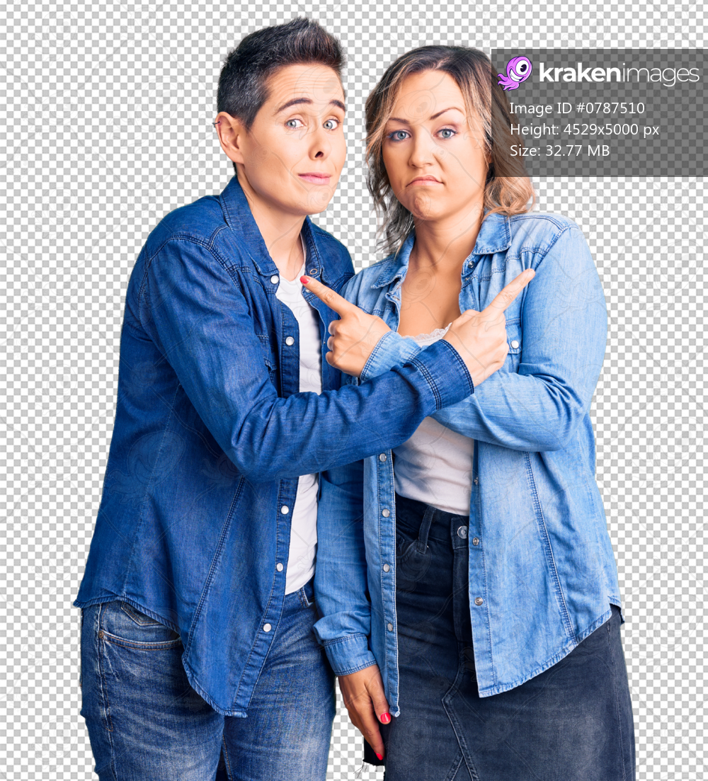 Couple of women wearing casual clothes pointing to both sides with fingers, different direction disagree