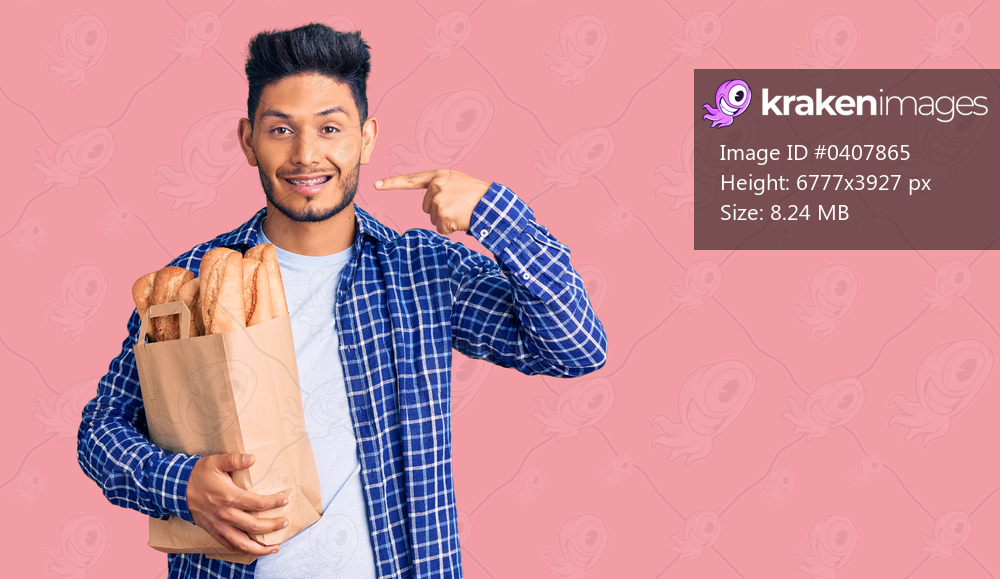 Handsome latin american young man holding paper bag with bread smiling cheerful showing and pointing with fingers teeth and mouth. dental health concept. 