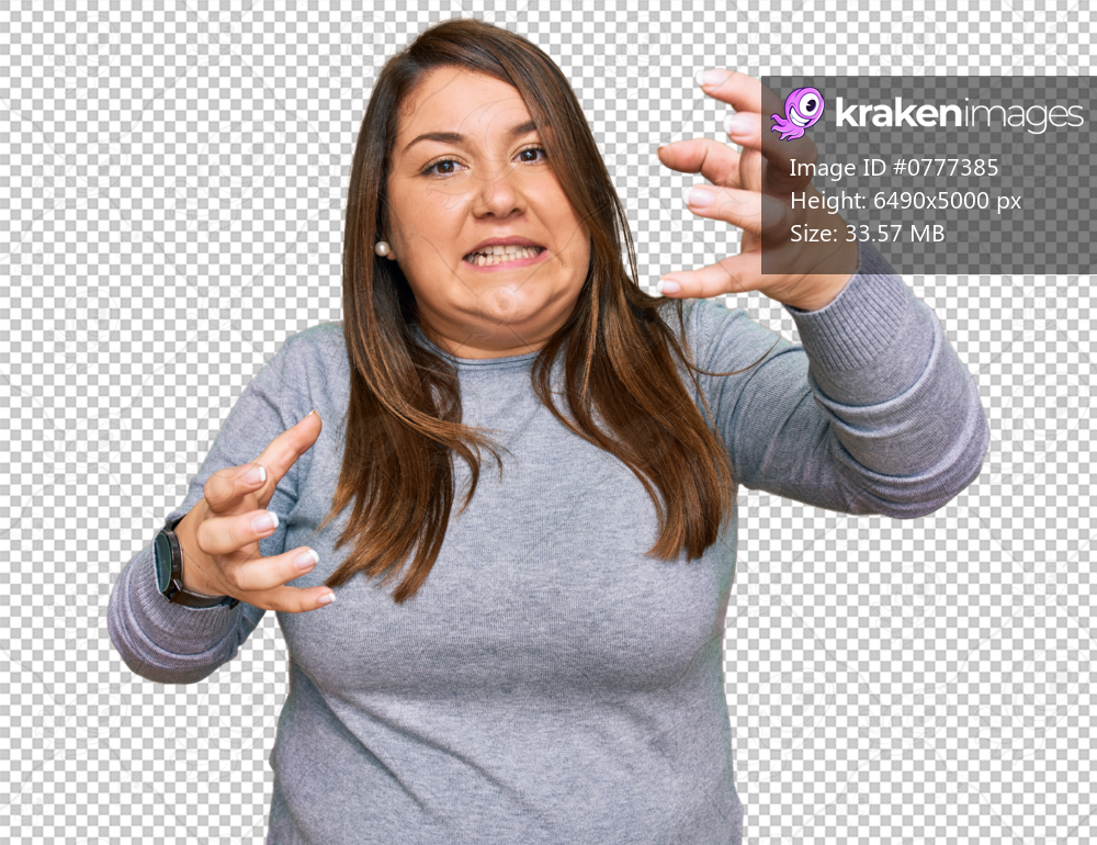 Beautiful brunette plus size woman wearing casual clothes shouting frustrated with rage, hands trying to strangle, yelling mad