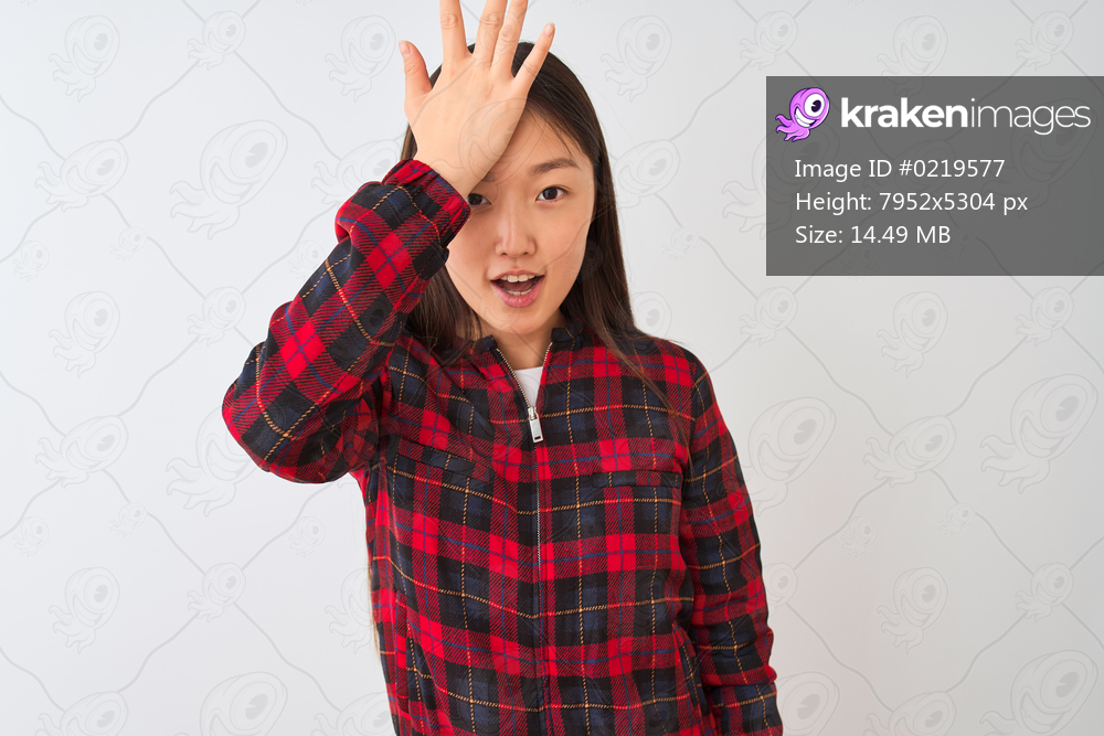 Young chinese woman wearing casual jacket standing over isolated white background surprised with hand on head for mistake, remember error. Forgot, bad memory concept.
