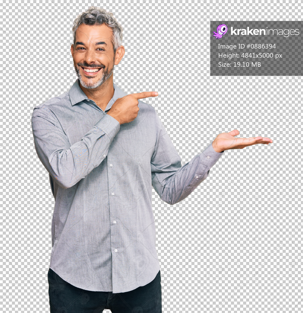 Middle age grey-haired man wearing casual clothes amazed and smiling to the camera while presenting with hand and pointing with finger.