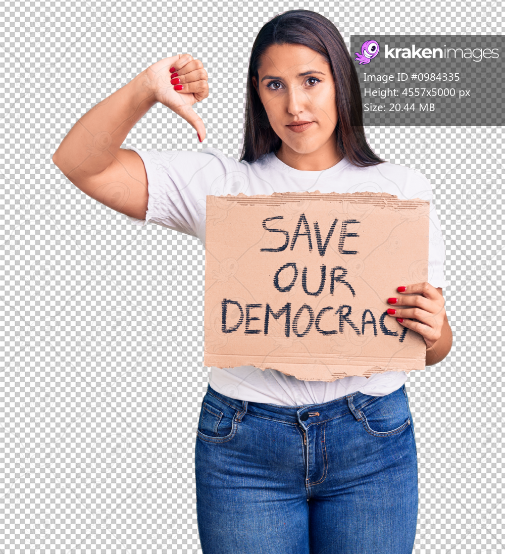 Young beautiful woman holding save our democracy cardboard banner with angry face, negative sign showing dislike with thumbs down, rejection concept