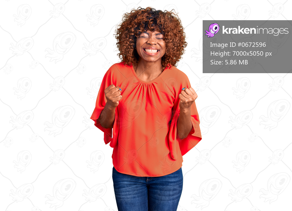 Young african american woman wearing casual clothes very happy and excited doing winner gesture with arms raised, smiling and screaming for success. celebration concept. 