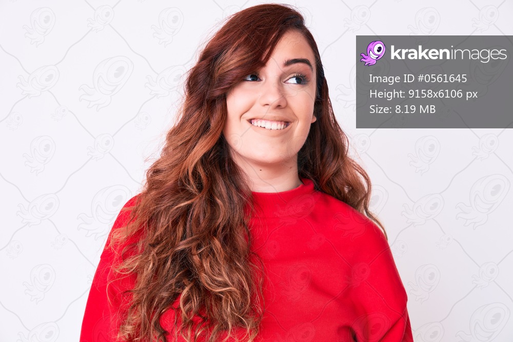Young beautiful woman wearing casual clothes looking away to side with smile on face, natural expression. laughing confident. 
