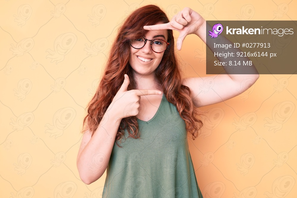 Young beautiful woman wearing casual clothes and glasses smiling making frame with hands and fingers with happy face. creativity and photography concept. 