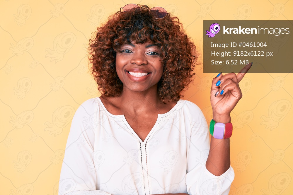Young african american woman wearing casual clothes smiling happy pointing with hand and finger to the side 