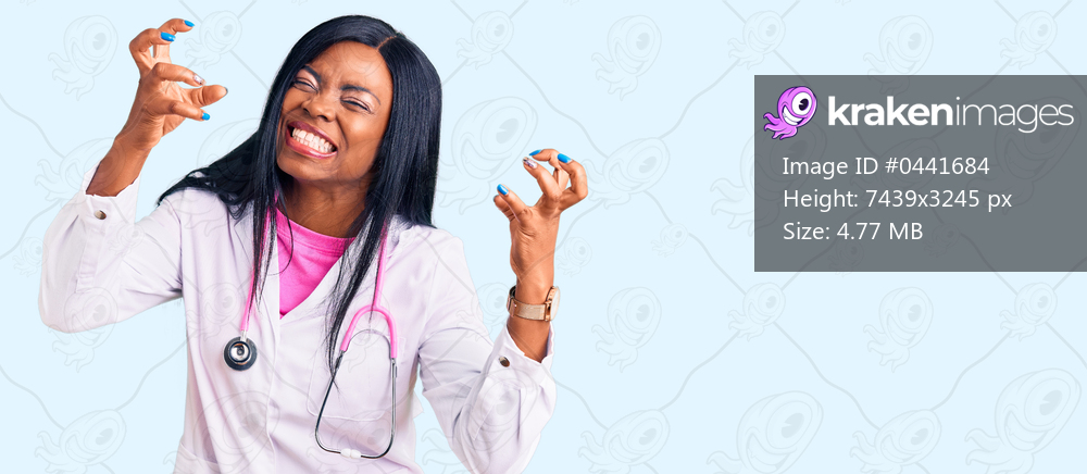 Young african american woman wearing doctor stethoscope shouting frustrated with rage, hands trying to strangle, yelling mad 
