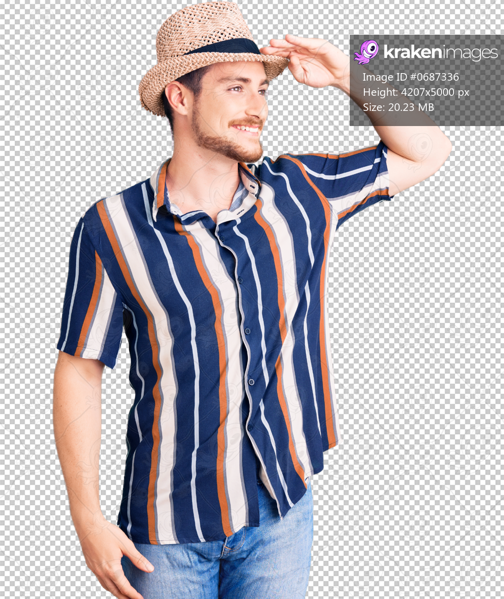 Young handsome caucasian man wearing summer hat very happy and smiling looking far away with hand over head. searching concept.