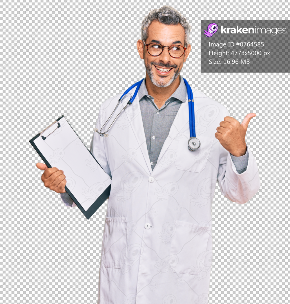 Middle age grey-haired man wearing doctor stethoscope holding clipboard pointing thumb up to the side smiling happy with open mouth