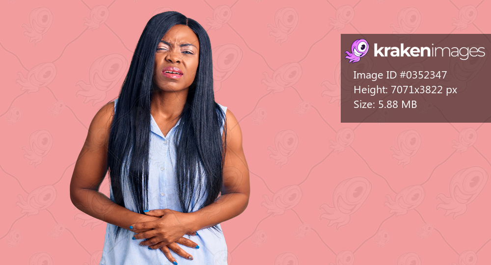 Young african american woman wearing casual clothes with hand on stomach because indigestion, painful illness feeling unwell. ache concept. 