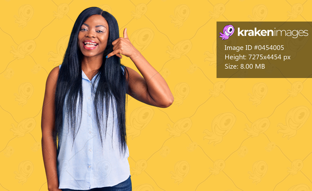 Young african american woman wearing casual clothes smiling doing phone gesture with hand and fingers like talking on the telephone. communicating concepts. 
