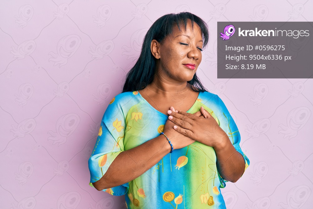 Middle age african american woman wearing casual clothes smiling with hands on chest, eyes closed with grateful gesture on face. health concept. 