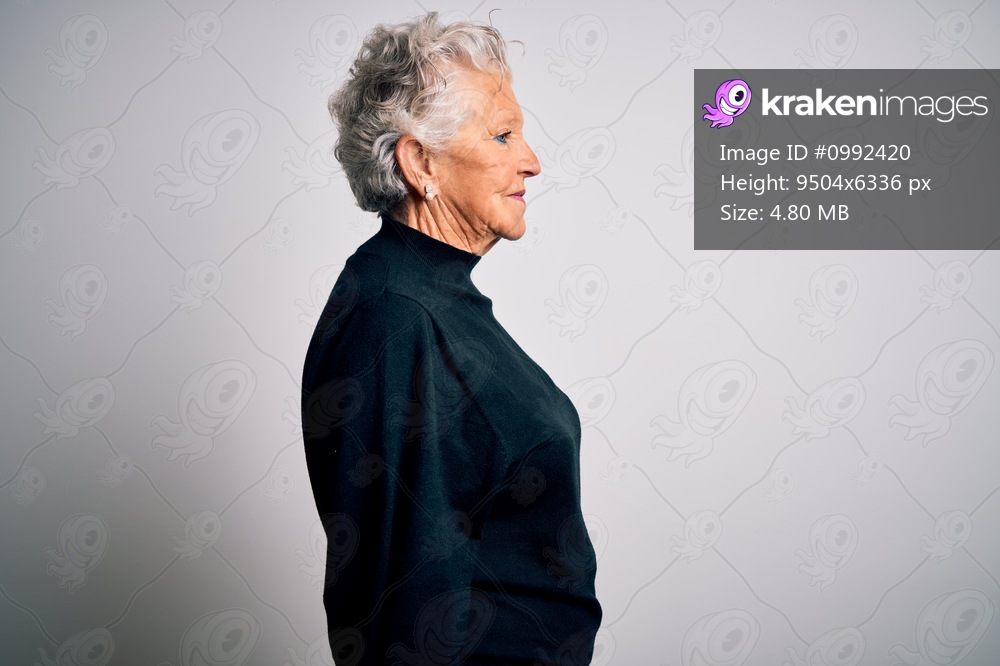 Senior beautiful woman wearing casual black sweater standing over isolated white background looking to side, relax profile pose with natural face with confident smile.